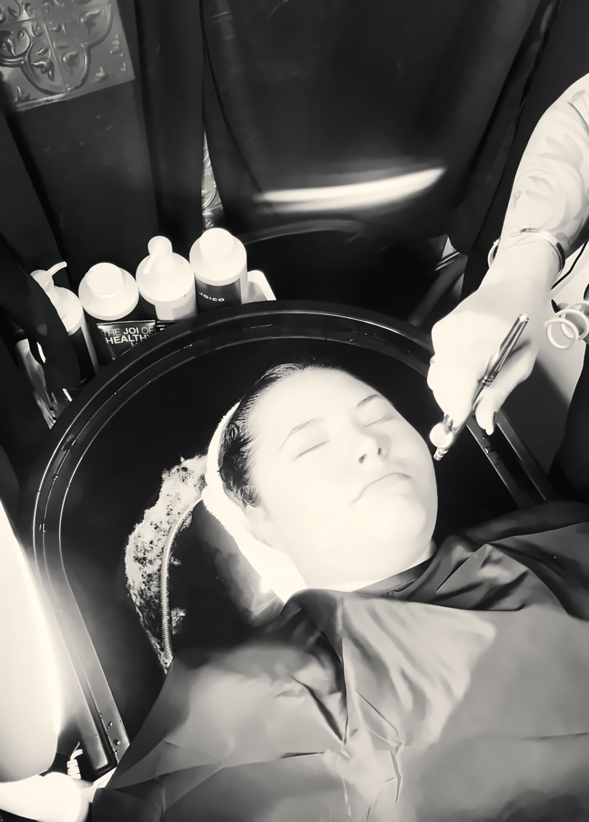 Client relaxing during a signature scalp and hair reset